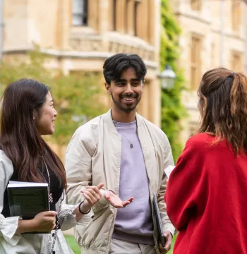 Students laughing with a range of Victorian buildings behind