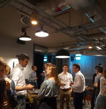 A group of Young Old Members chatting in a pub