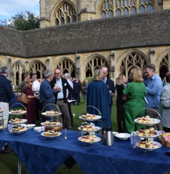 Afternoon tea is laid out in the cloisters as guests gather and chat