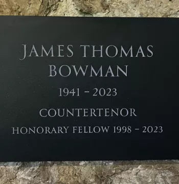 The plaque to James Bowman in the cloisters. It reads: James Thomas Bowman, 1941-2023. Countertenor. Honorary Fellow, 1998-2023.