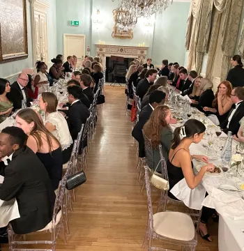The dining room: two tables filled with guests enjoying a meal at Dartmouth House, Mayfair