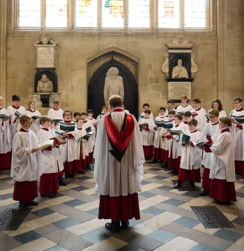 A picture of New College Choir standing in the New College Antechapel, taken by Ian Wallman